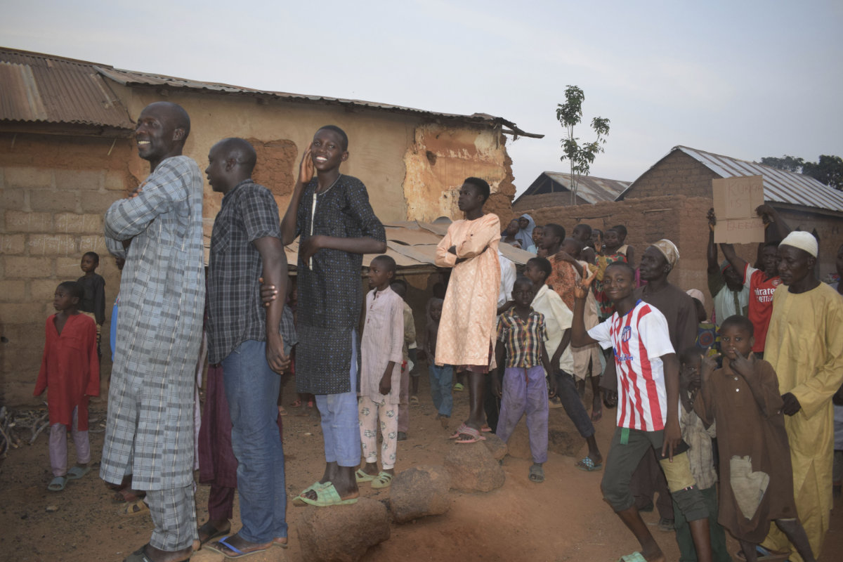 People gather around an area were gunmen kidnapped school children in Chikun, Nigeria, on March 7, 2024. (AP Photo)