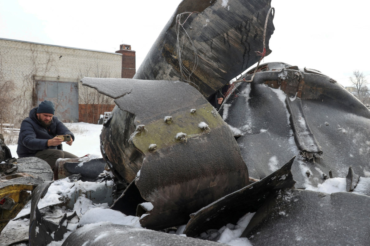 A man photographs parts of an unidentified missile, which Ukrainian authorities believe to be made in North Korea and was used in a strike in Kharkiv earlier this week. (REUTERS)