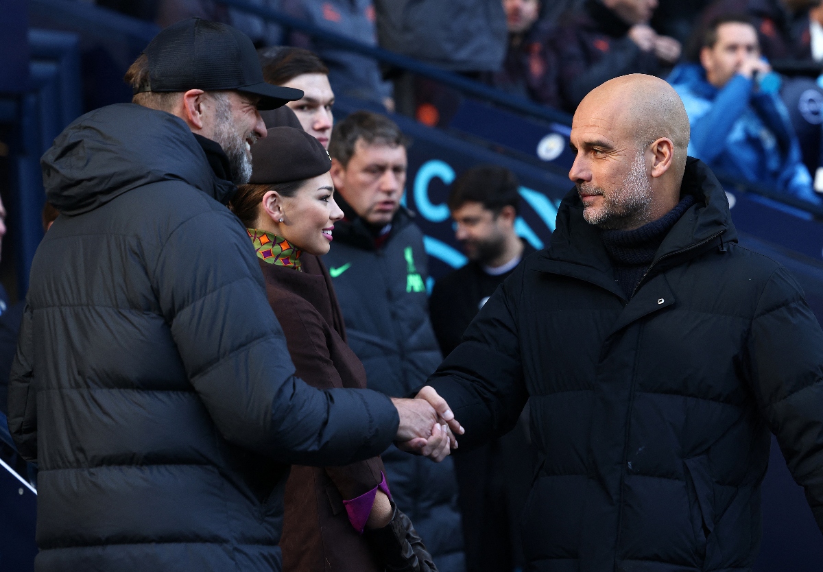 Manchester City's Spanish manager Pep Guardiola greets Liverpool's German manager Jurgen Klopp ahead of their English Premier League football match at the Etihad Stadium in Manchester, north west England, on Nov. 25, 2023. (AFP)