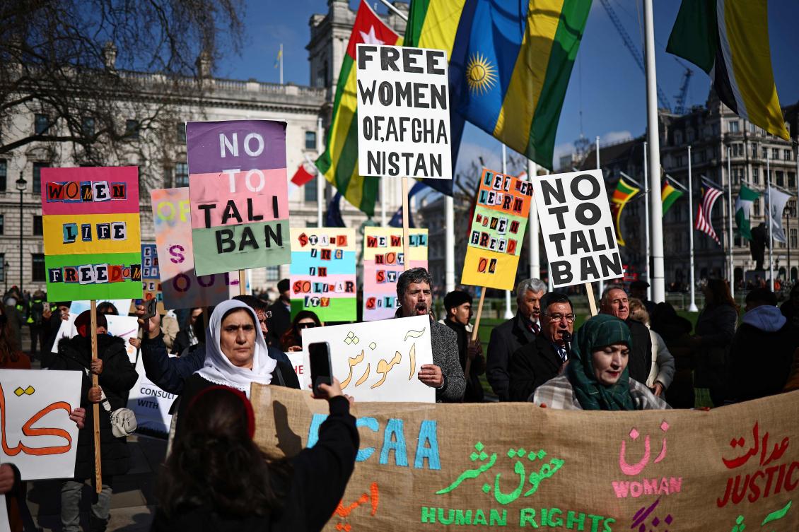 Protesters hold placards at a demonstration calling for women’s rights in Afghanistan, in Parliament Square in London on Mar. 8, 2024, on International Women’s Day. (AFP)