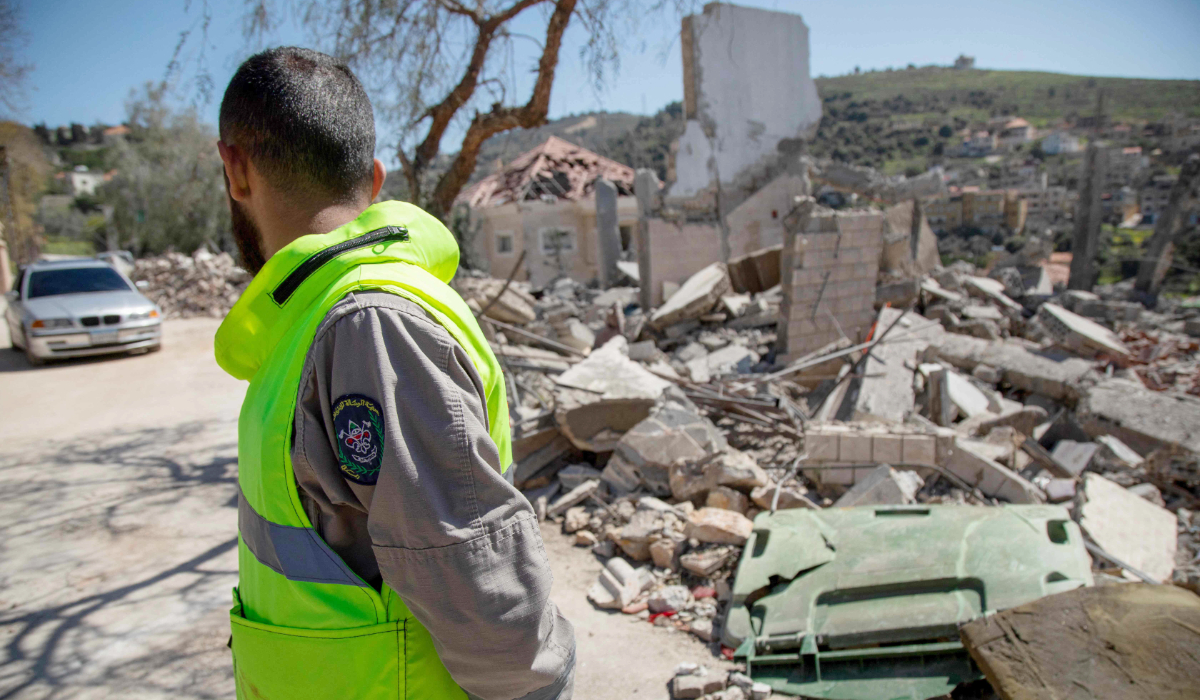 A paramedic looks at the site of an Israeli airstrike a day earlier in the southern Lebanese village of Odaisseh near the border with Israel on March 5, 2024, amid ongoing cross-border tensions as fighting continues between Israel and Palestinian Hamas militants in the Gaza Strip. (AFP)