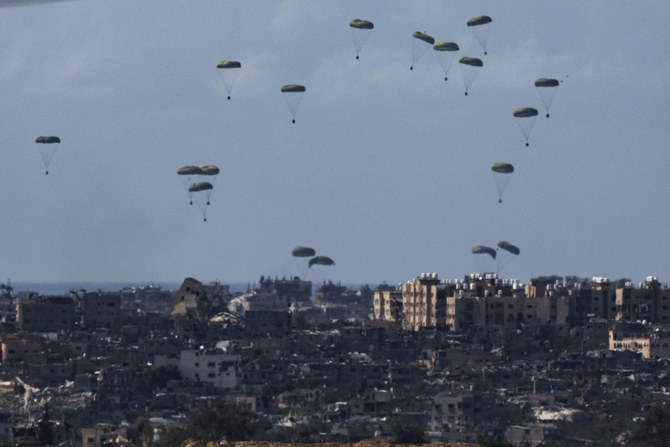 Parachutes drop supplies into the northern Gaza Strip, as seen from southern Israel, on March 8, 2024. (AP)