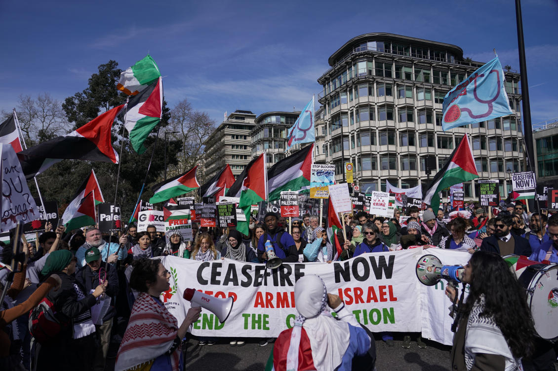Demonstrators hold banners and flags as they gather ahead of a march in support of the Palestinian people in Gaza, in London, on Mar. 9, 2024. (AP)