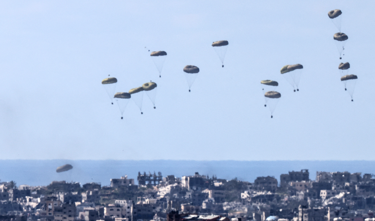 In this picture taken from Israel’s southern border with the Gaza Strip shows humanitarian aid being airdropped over the Palestinian territory on March 10, 2024. (AFP/File)