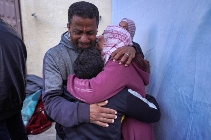 Palestinians mourn death of family member in Al-Aqsa Martyrs Hospital in Deir Al-Balah, after he was killed in Israeli strikes on the makeshift Al-Mawasi camp west of Khan Yunis. (AFP/File)