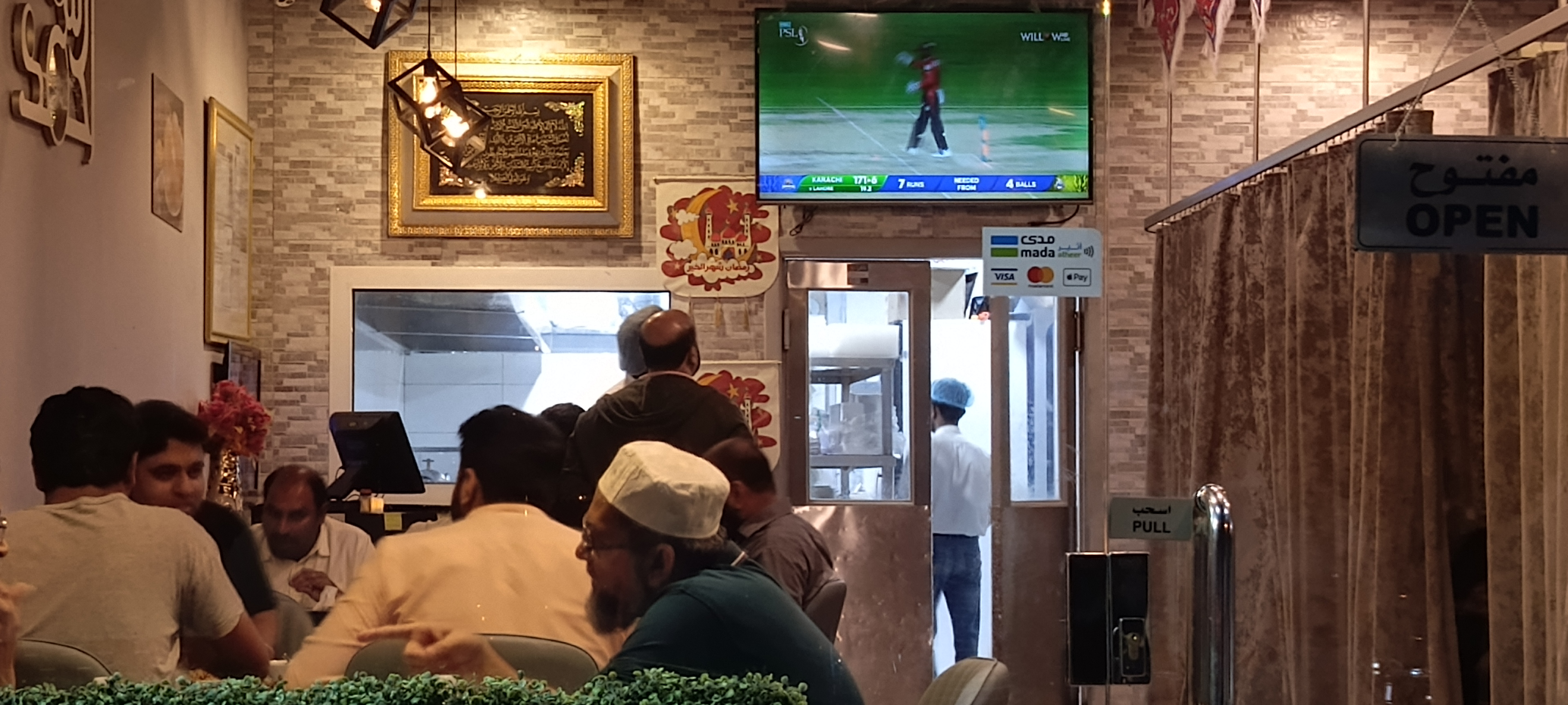 Fans enjoying food while watching PSL match at a restaurant in Riyadh (AN photo/ Rashid Hassan)