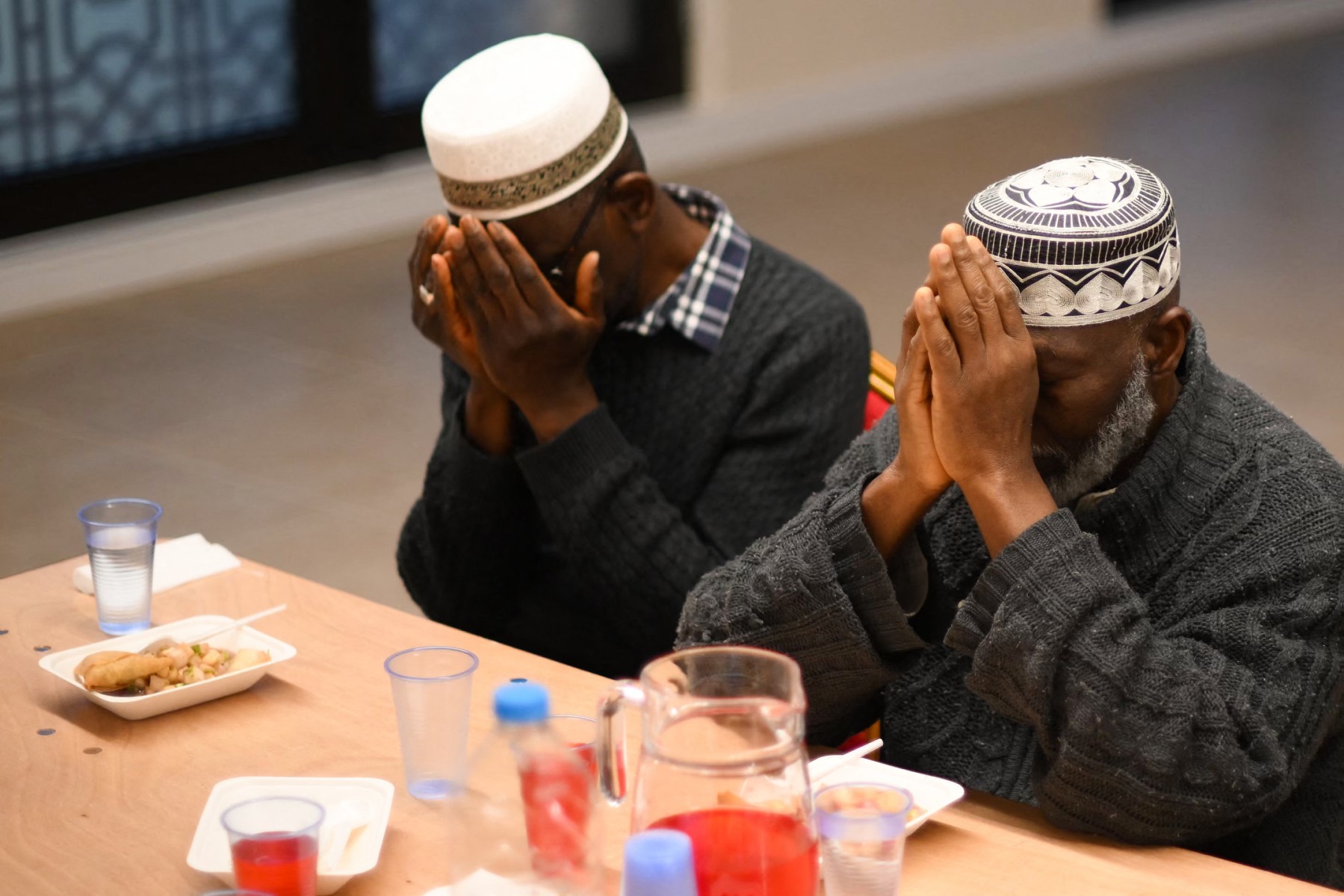 Members of the Ahmadiyya Muslim Community pray as they attend a communal Iftar, the breaking of fast dinner, during the Islamic holy month of Ramadan, at the Baitul Futuh Mosque, south west London, on April 15, 2023. (File/AFP)