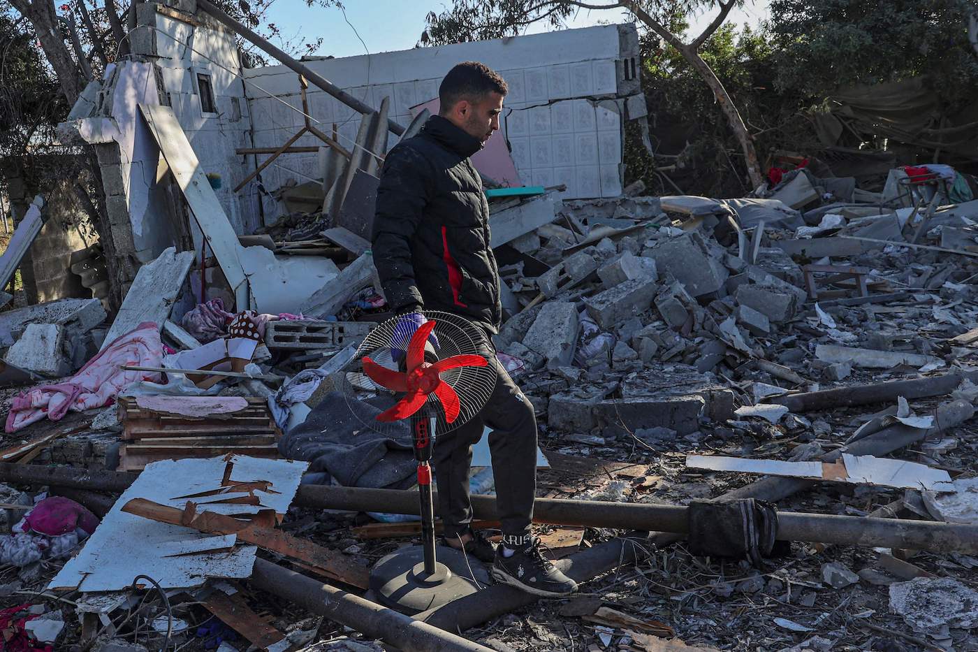 A Palestinian searches for his belongings amid the rubble of houses destroyed by Israeli bombardment in Rafah, the southern Gaza Strip, March 11, 2024. (AFP)