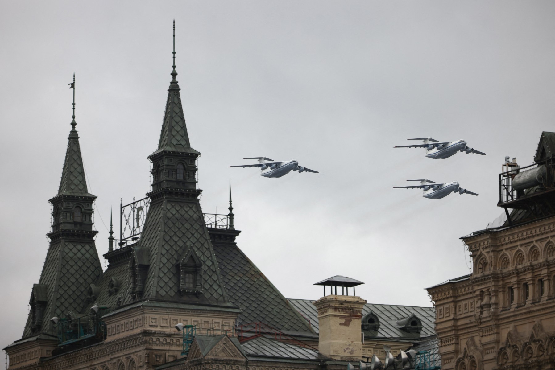 Russian Ilyushin Il-76 planes fly over the GUM department store during the Victory Day military parade in Moscow on May 9, 2021. (AFP)