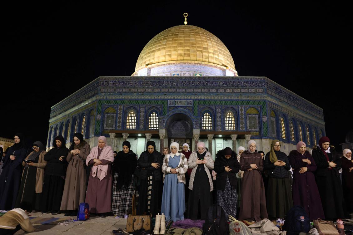 Palestinian Muslim devotees perform an evening prayer known as 'Tarawih' outside the Dome of the Rock in Jerusalem's al-Aqsa Mosque compound during the holy fasting month of Ramadan. (AFP)