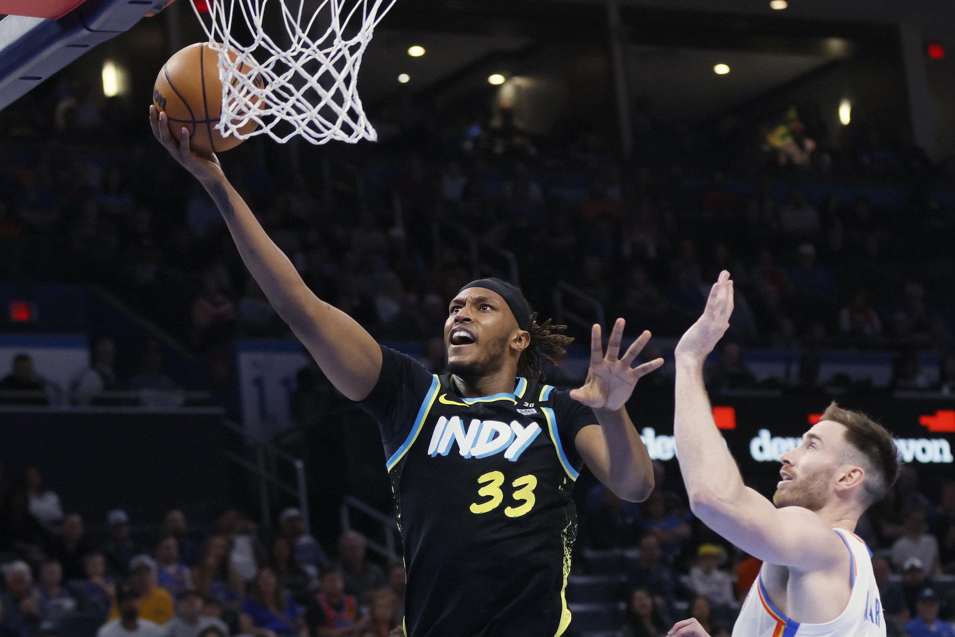 Indiana Pacers center Myles Turner shoots next to Oklahoma City Thunder forward Gordon Hayward, right, during the second half of an NBA basketball game Tuesday in Oklahoma City. (AP)
