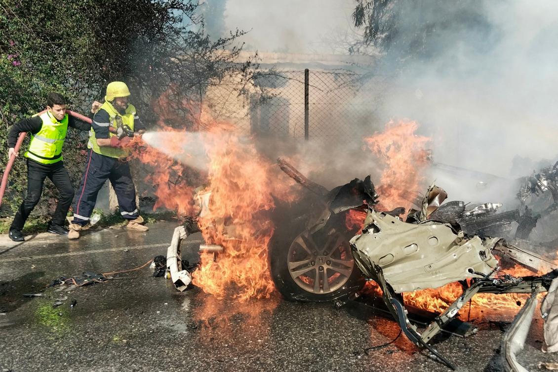 Firefighters douse a burning car after it was hit in a reported Israeli drone attack in Lebanon's southern area of Naqoura near the border with Israel amid ongoing cross-border tensions. ( AFP)