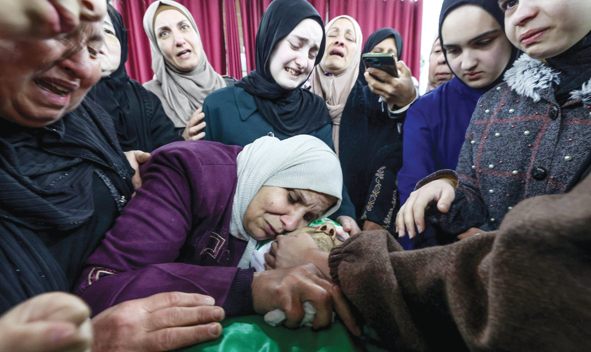 Relatives surround the body of Mahmud Abu Alheja, one of the two Palestinians killed by Israeli forces in Jenin, occupied West Bank, before their funeral on Wednesday. (AFP)