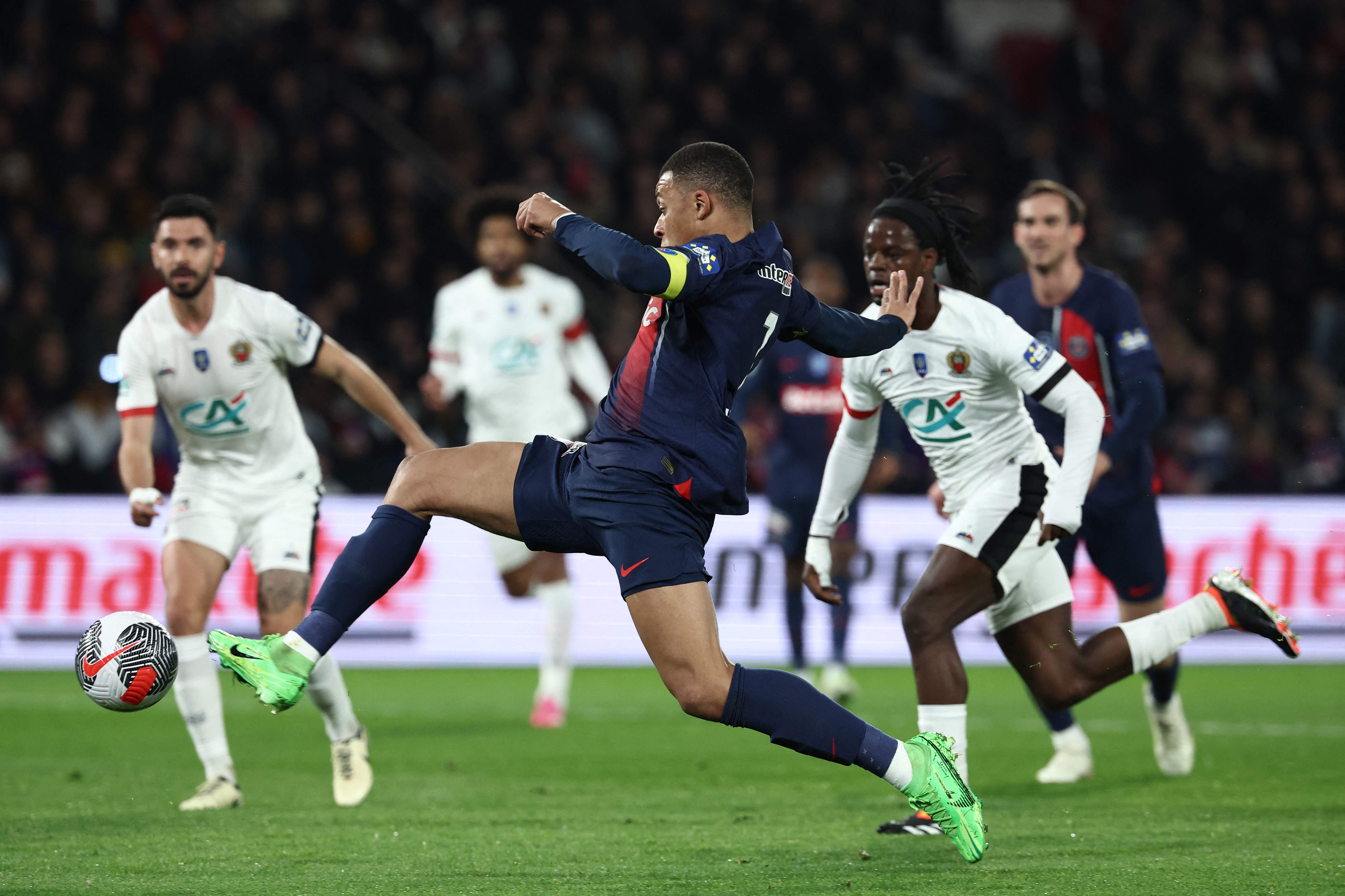 Paris Saint-Germain's French forward Kylian Mbappe shoots and scores his team's first goal during the French Cup (Coupe de France) quarterfinal football match between PSG and OGC Nice at the Parc des Princes stadium, in Paris. (AFP)