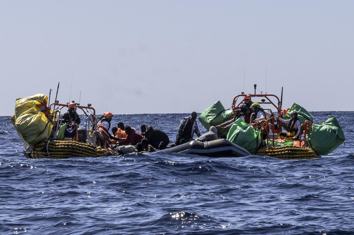 Migrants are helped evacuate a partially deflated rubber dinghy by the rescue personnel of the SOS Mediterranee humanitarian ship Ocean Viking in the Central Mediterranean Sea, on Mar. 12, 2024. (AP)