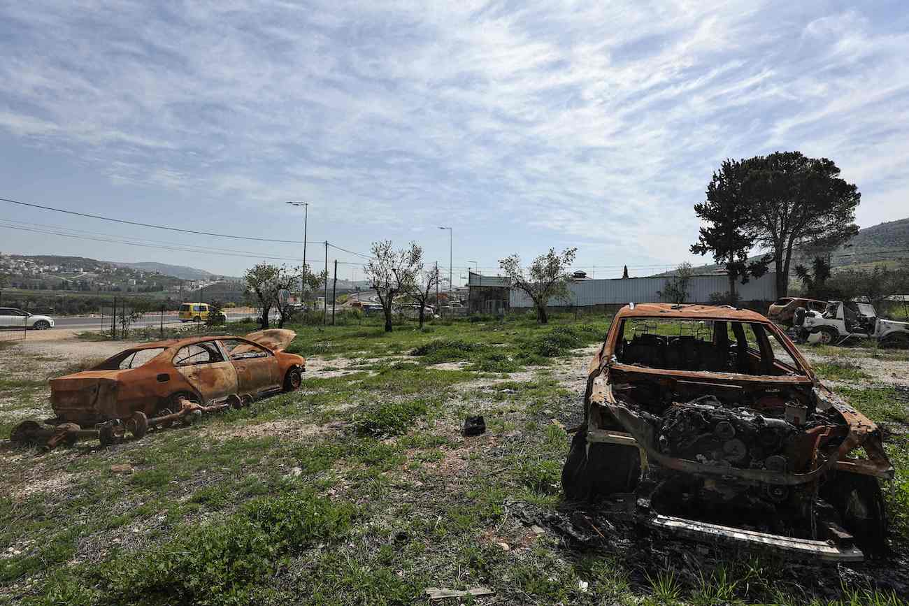 Burnt car carcasses rust in a field near a Palestinian auto garage which was reportedly attacked by Israeli settlers in Huwara, occupied West Bank, March 13, 2024. (AFP)