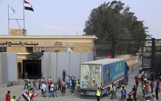A truck carrying humanitarian aid for the Gaza Strip crosses the Rafah border gate in Rafah. (AP)
