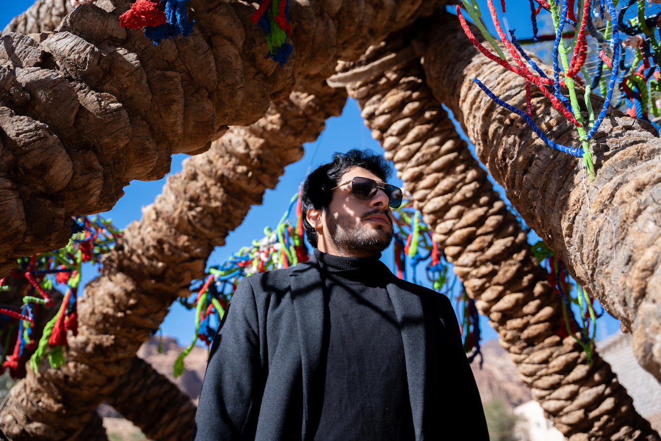 Obaid Alsafi with his Ithra Art Prize-winning work 'Palms in Eternal Embrace' at AlUla Arts Festival. (Supplied)