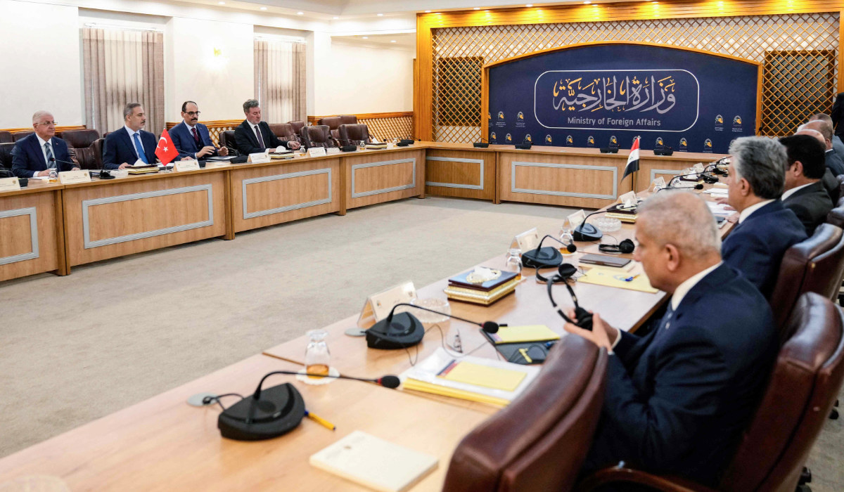 Iraq's foreign minister and other officials (R) meet with a visiting Turkish delegation headed by Foreign Minister Hakan Fidan (2-L)in Baghdad on March 14, 2024. (AFP)