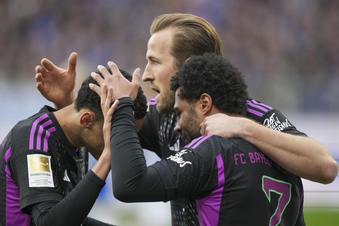 Bayern’s Serge Gnabry celebrates with his teammates Harry Kane and Jamal Musiala after he scored his side’s fourth goal during their Bundesliga match against SV Darmstadt 98 in Darmstadt on Mar. 16, 2024. (AP)