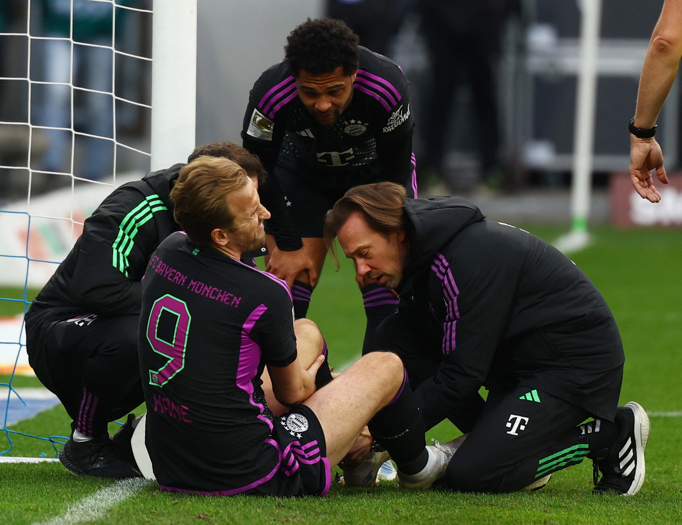 Bayern Munich's Harry Kane receives medical attention after sustaining an injury during a Bundesliga match against Darmstadt on Saturday. (Reuters)