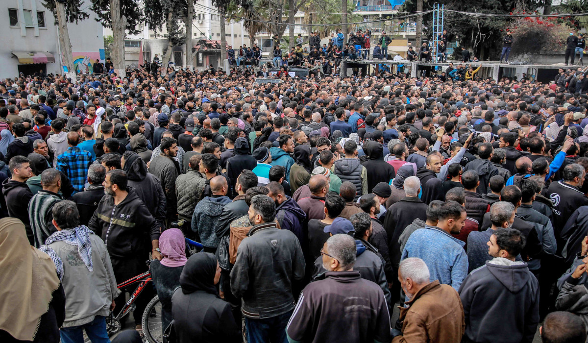 Palestinians queue during the distribution of humanitarian aid in Gaza City on March 17, 2024, amid ongoing battles between Israel and the militant group Hamas. (AFP)