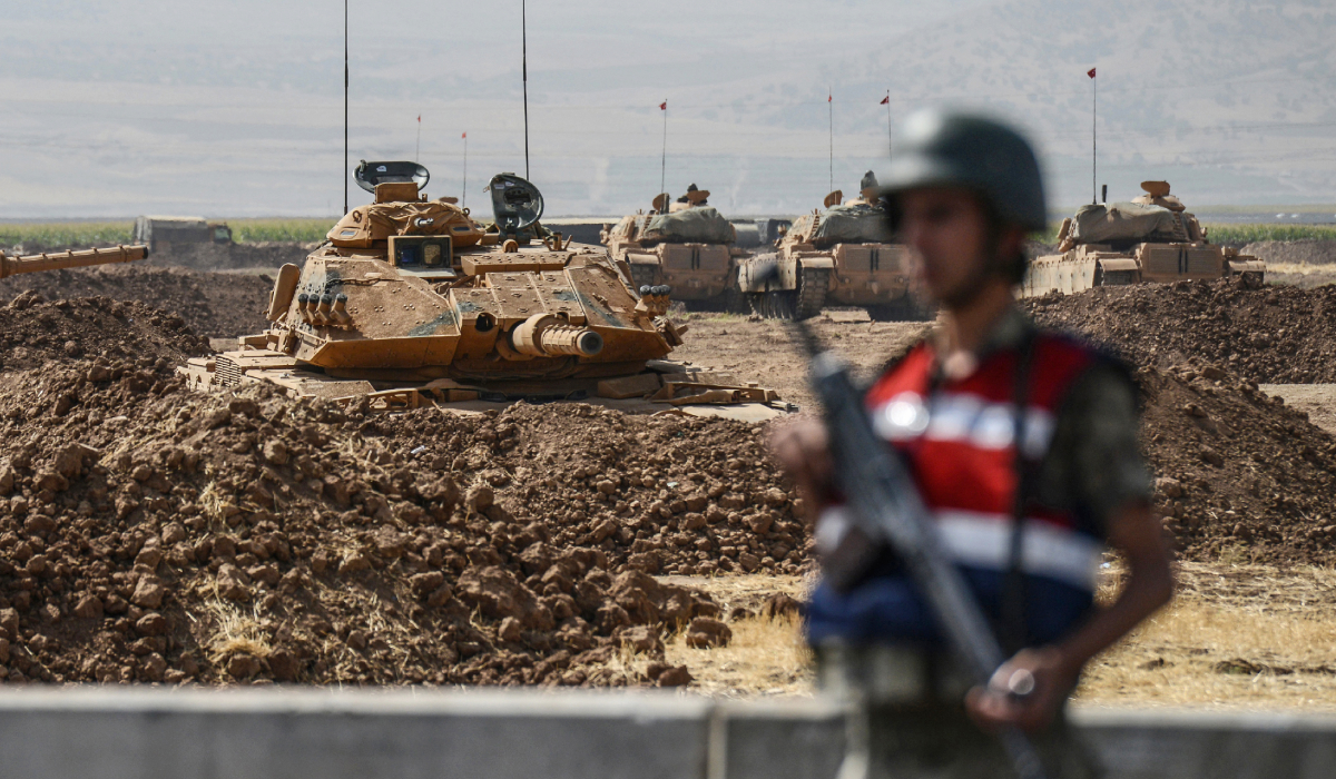 Turkish tanks are seen as a Turkish genderme stands guard near the Habur crossing gate between Turkey and Iraq during a military drill at Silopi district. (AFP file photo)