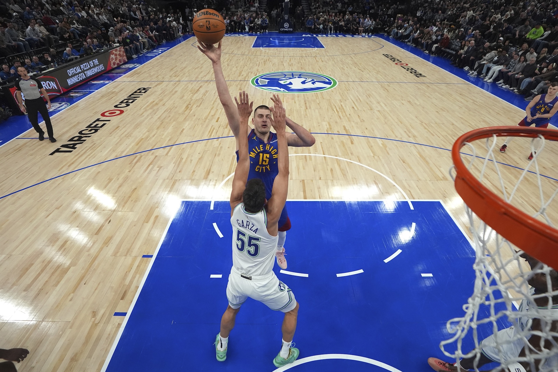 Denver Nuggets center Nikola Jokic (15) shoots over Minnesota Timberwolves center Luka Garza (55) during the first half of an NBA basketball game Tuesday in Minneapolis. (AP)