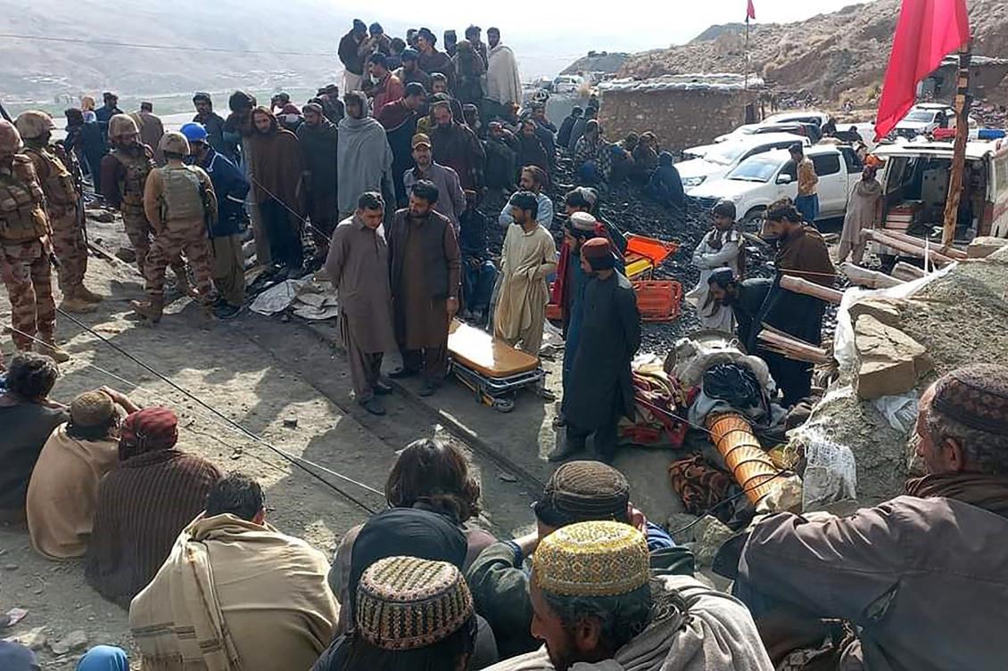 Miners gathered outside the collapsed mine as rescue personnel conducted a search operation for trapped workers after a gas explosion rocked the private coal pit in the mining region of Khost at Harnai district, Balochistan province. (AFP PHOTO/MINES AND MINERALS DEVELOPMENT DEPARTMENT BALOCHISTAN)