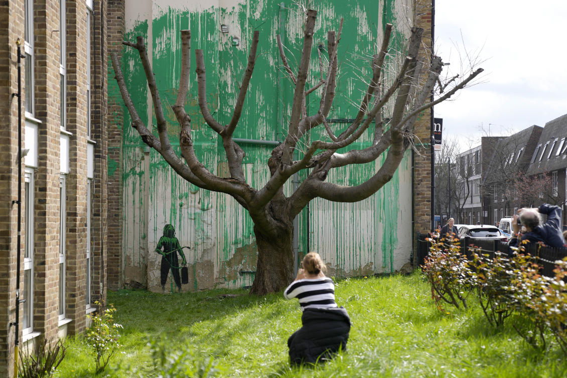 People look at a new Banksy painting on a wall in London, on Mar. 18, 2024. (AP)