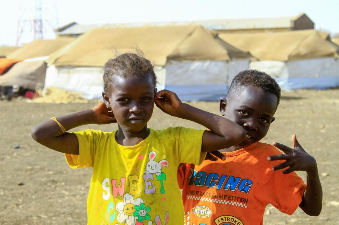 A picture taken on March 20, 2024, shows children who fled Khartoum and Jazira states in war-torn Sudan playing near tents at a camp for the internally displaced in southern Gadaref state. (AFP)