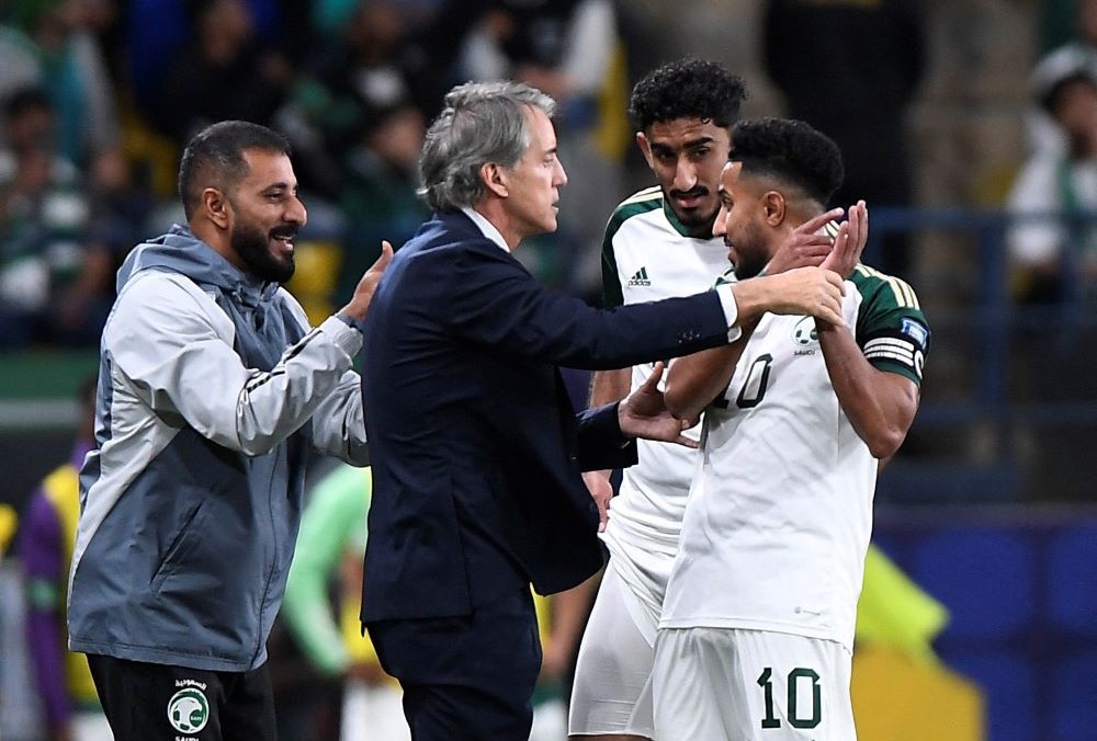 Saudi Arabia’s Salem Al-Dawsari celebrates, with Roberto Mancini, after scoring against Tajikistan, Al-Awwal Stadium, Riyadh, Saudi Arabia, Mar. 21, 2024. (Reuters)