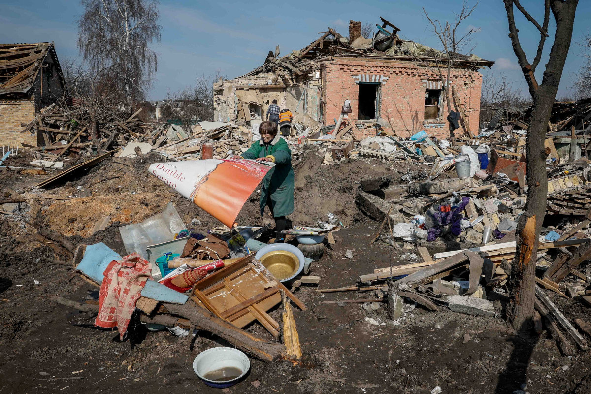 A local resident throws stuff near her house destroyed during a Russian missile strike near Kyiv, Ukraine, on March 21, 2024. (REUTERS)