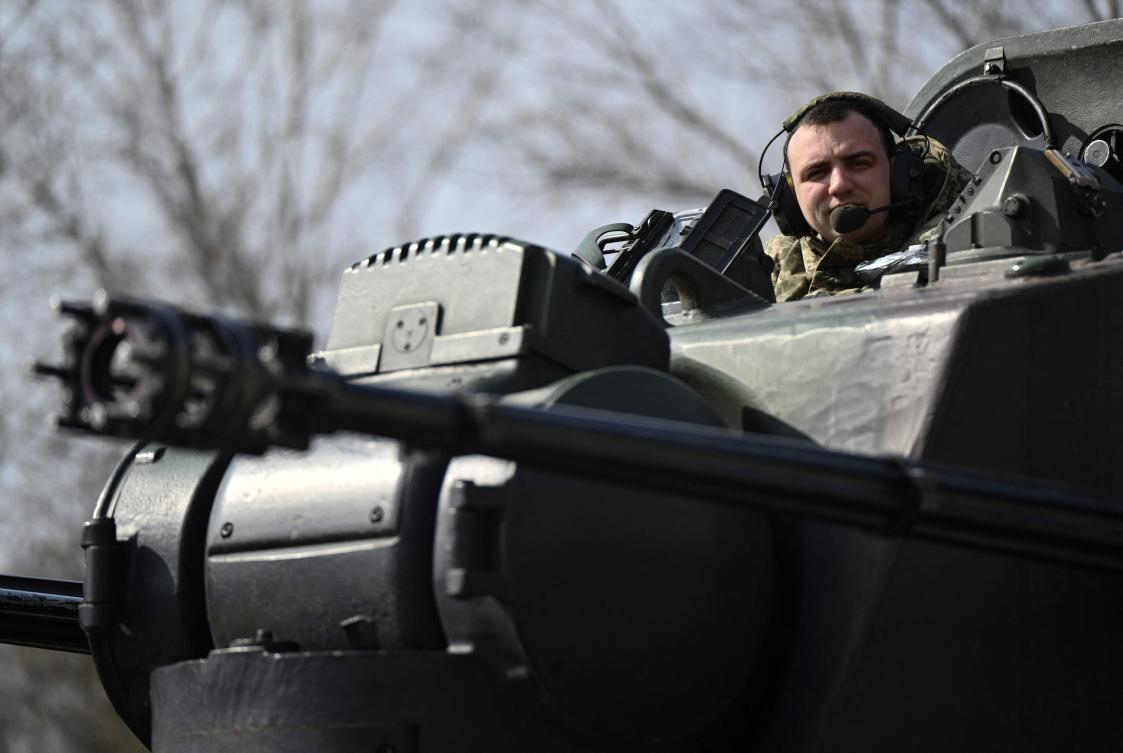 A Ukrainian serviceman aboard a German-made self-propelled anti-aircraft, better known as the Flakpanzer Gepard, prepares for a combat duty in Kyiv region on March 21, 2024. (AFP)