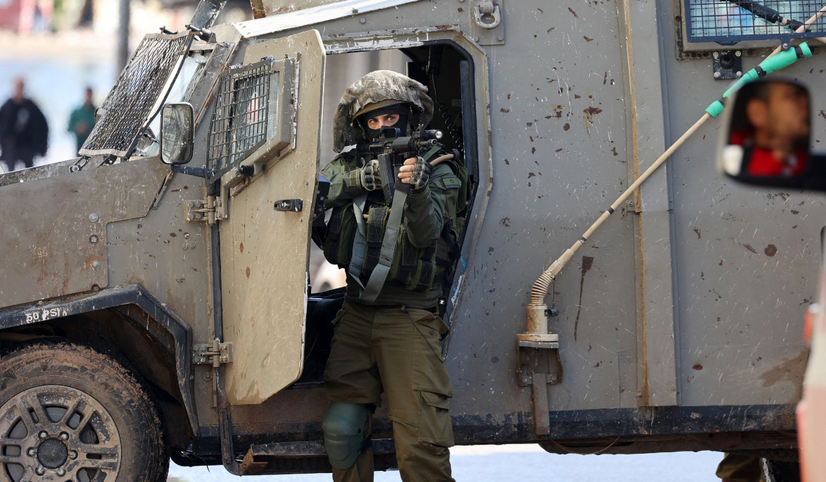 An Israeli soldier gestures on December 13, 2023 following an overnight army raid in Jenin in the occupied West Bank, as battles continue between Israel and the militant movement Hamas in Gaza. (AFP)