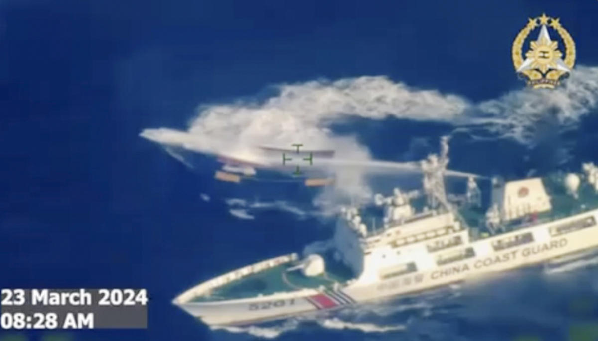 A Chinese coast guard ship uses water cannon on Philippine resupply vessel Unaizah May 4 as it approaches Second Thomas Shoal, locally called Ayungin shoal, at the disputed South China Sea on March 23, 2024. (Armed Forces of the Philippines via AP)