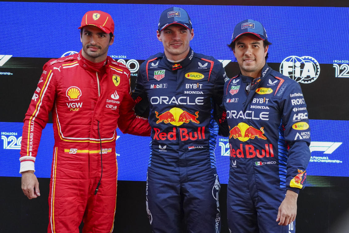 Fastest qualifier Red Bull driver Max Verstappen, center, of the Netherlands stands with second fastest, Ferrari driver Carlos Sainz, left, of Spain and Red Bull teammate and third placed Sergio Perez of Mexico following the qualifying session for the Australian F1 Grand Prix at Albert Park, in Melbourne, on Mar. 23, 2024. (AP)