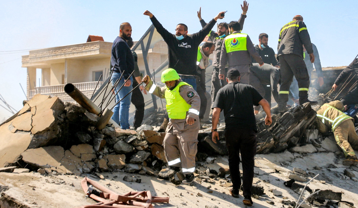 Lebanese civil defence members search the rubble of a destroyed building in the aftermath of an Israeli airstrike on the village of Sarein, near Baalbek in east central Lebanon. (AFP file photo)