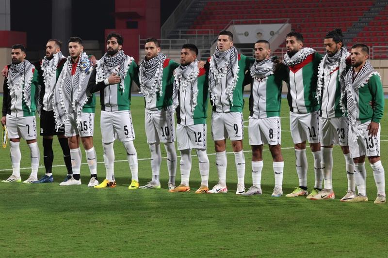 Palestine's starting eleven gather for their national anthem ahead of the 2026 FIFA World Cup AFC qualifiers football match between Lebanon and Palestine at the Khalid Bin Mohammed Stadium in Sharjah on Nov, 16, 2023. (AFP)