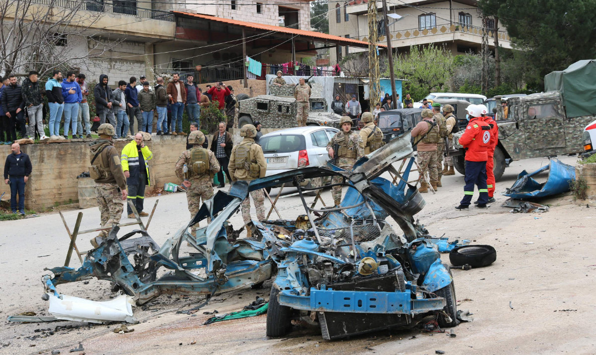 Lebanese soldiers cordon off the site of an Israeli drone attack targeting a vehicle in western Bekaa Valley on Sunday. (AFP)