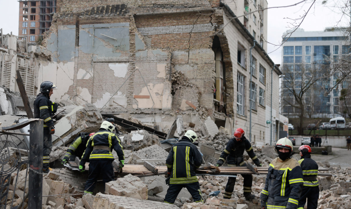 Rescuers work at the site of a building damaged by a Russian missile strike, amid Russia's attack on Ukraine, in Kyiv, Ukraine March 25, 2024. (Reuters)