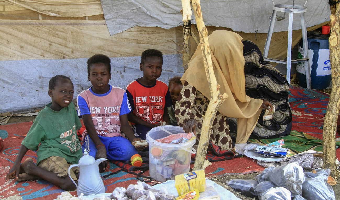 A picture taken on March 20, 2024, shows people who fled Khartoum and Jazira states in war-torn Sudan sitting in a tent at a camp for the internally displaced in southern Gadaref state. (AFP/File)