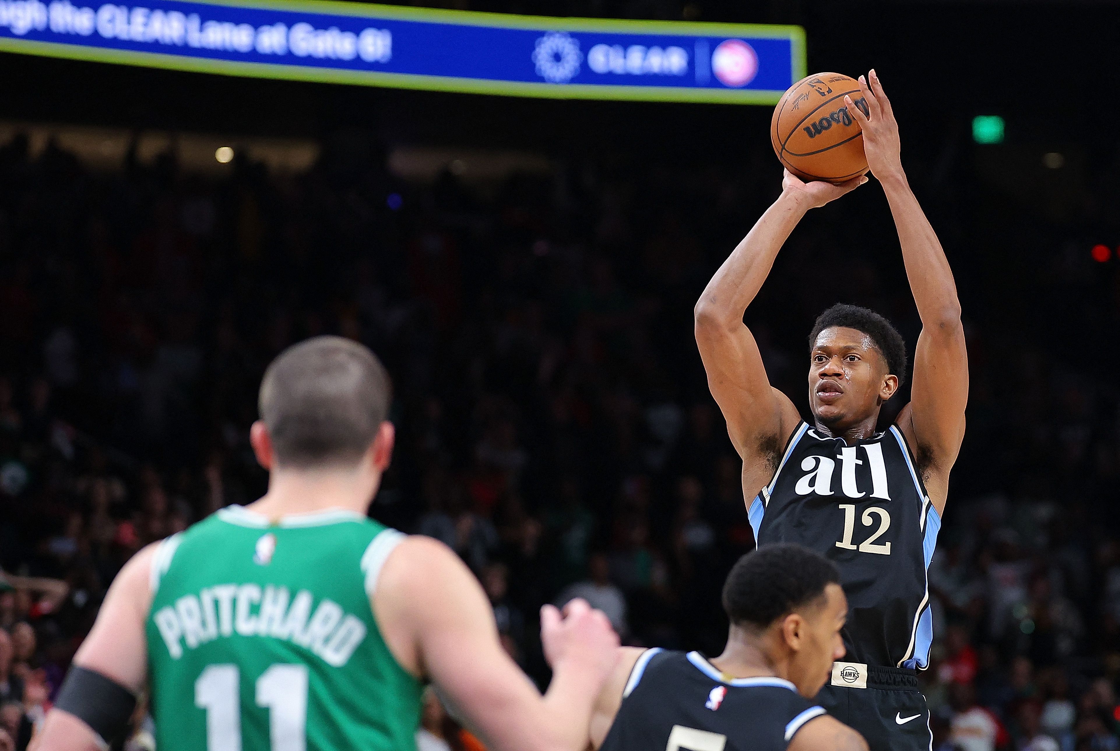De'Andre Hunter of the Atlanta Hawks shoots a three-point basket in the final seconds against the Boston Celtics during the fourth quarter of an NBA game at State Farm Arena in Atlanta, Georgia. (AFP)