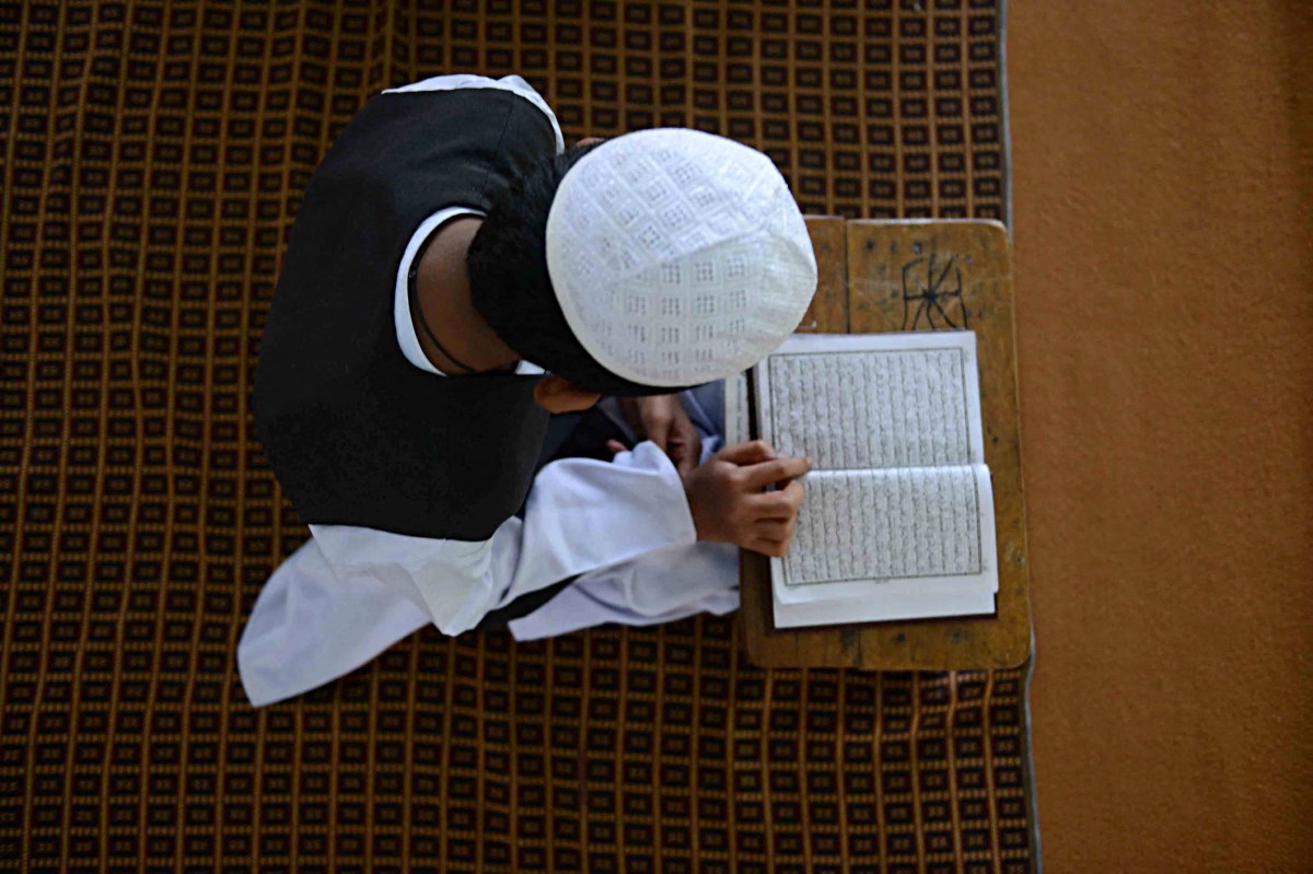 An Indian Muslim student reads the Qur'an at Madrasa Imam Anwaarullah in Hyderabad on June 14, 2016. (AFP)