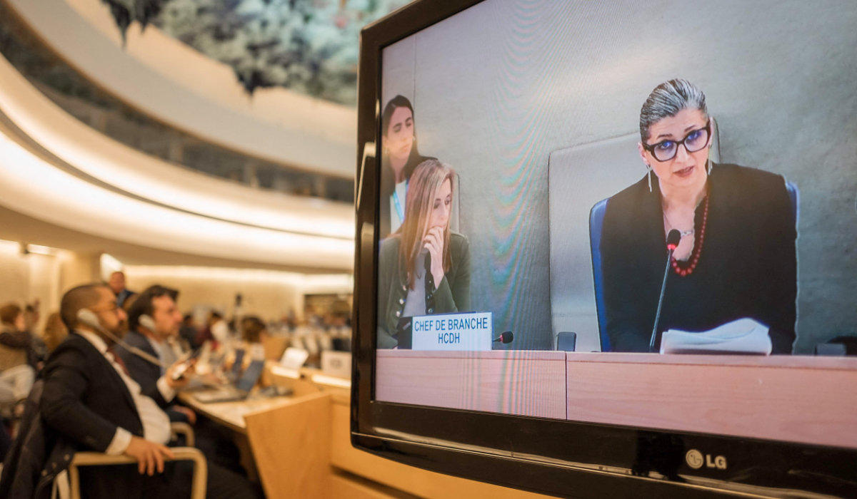 United Nations (UN) Special Rapporteur on the Rights Situation in the Palestinian Territories, Francesca Albanese, is seen on a TV screen delivering her rapport during a session of the UN Human Rights Council, in Geneva, on March 26, 2024. (AFP)