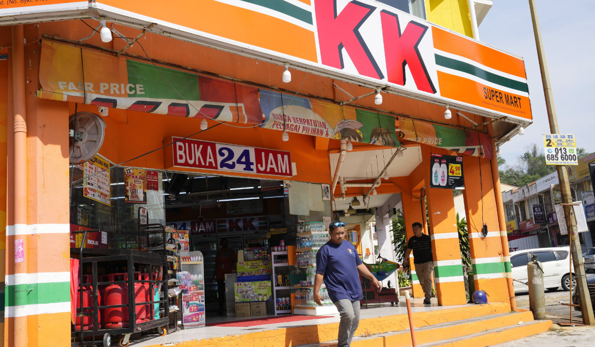 A customer walk out from KK Mart convenience store in Puchong area on the outskirts of of Kuala Lumpur, Malaysia, Tuesday, March 26, 2024. (AP)