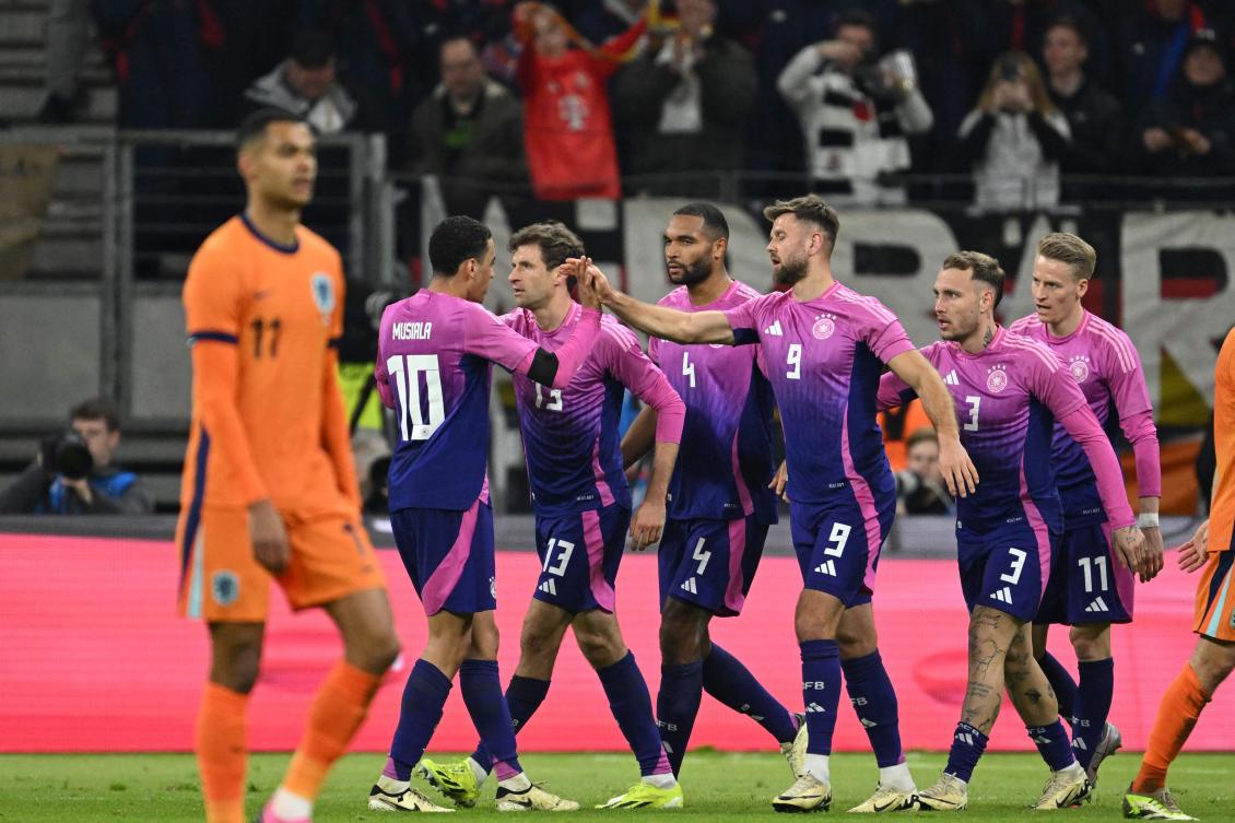 Germany’s forward Niclas Fullkrug celebrates with team mates after scoring the 2-1 goal during their friendly match against the Netherlands in Frankfurt on Mar. 26, 2024. (AFP)