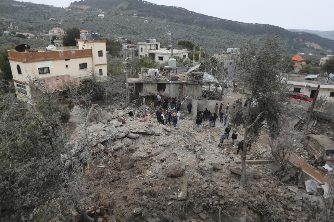 People gather on the rubble of a paramedic center that was destroyed by an Israeli airstrike early Wednesday in Hebbariye village, south Lebanon, on Mar. 27, 2024. (AP)