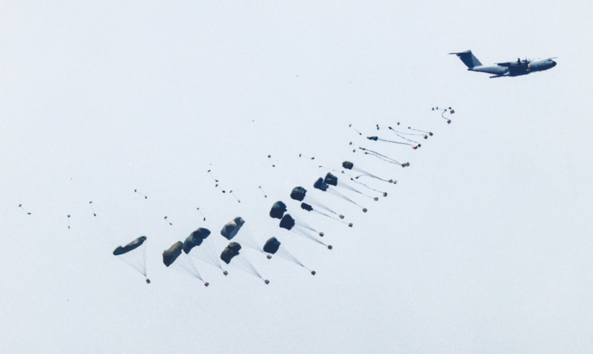 This picture taken from Israel’s southern border with the Gaza Strip shows a military aircraft releasing parachutes of humanitarian aid over the besieged Palestinian territory. (AFP)