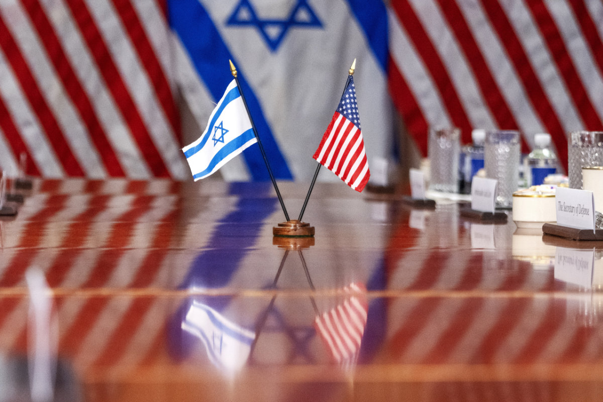 An Israeli and US flag are reflected on a conference table as Defense Secretary Lloyd Austin meets with Israeli Defense Minister Yoav Gallant at the Pentagon in Arlington, Virginia, on March 26, 2024. (AP)